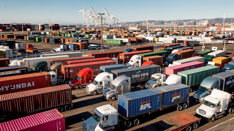 FILE - Trucks line up to enter a Port of Oakland shipping terminal on Wednesday, Nov. 10, 2021, in Oakland, Calif. The federal government is moving forward with a plan to let teenagers drive big rigs from state to state in a test program. Currently, 