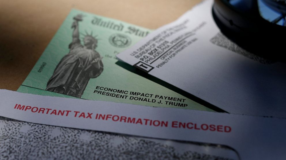 FILE - In this April 23, 2020, file photo, President Donald Trump's name is seen on a stimulus check issued by the IRS to help combat the adverse economic effects of the COVID-19 outbreak, in San Antonio. All that aid is now gone. Yet prospects for m