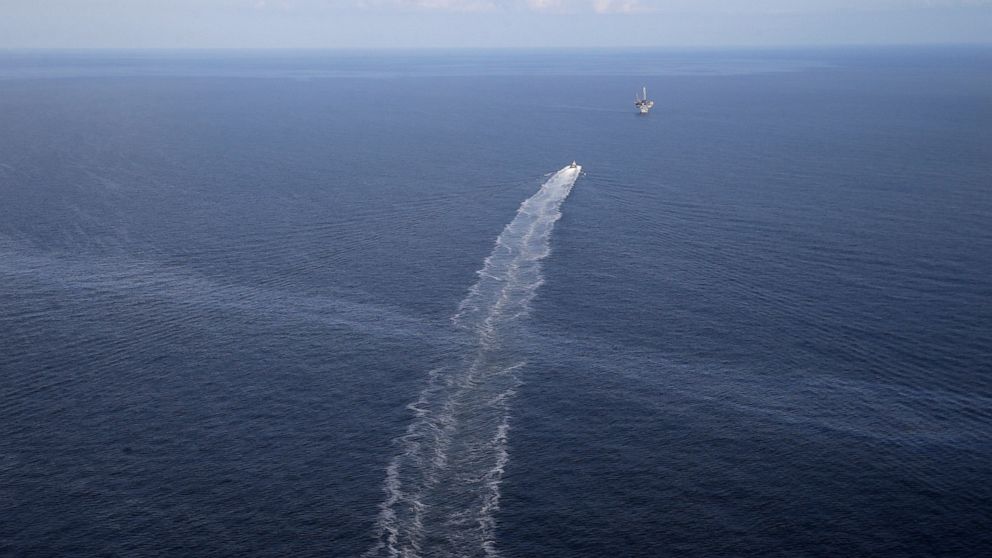 FILE - In this March 31, 2015 file photo, the wake of a supply vessel heading towards a working platform crosses over an oil sheen drifting from the site of the former Taylor Energy oil rig in the Gulf of Mexico, off the coast of Louisiana. Federal p