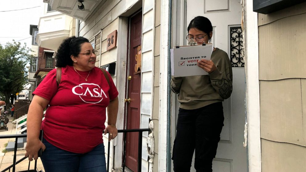 Mirna Orellana, left, a community organizer from the non-profit group We Are Casa, helps Karyme Navarro, right, fill out a voter registration form in York, Pa., on Sept. 30, 2019. Democrats are counting on Hispanics so enraged by President Donald Tru