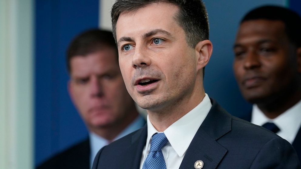 FILE - Transportation Secretary Pete Buttigieg, center, speaks during a briefing at the White House in Washington, May 16, 2022, as Labor Secretary Marty Walsh, left, and Environmental Protection Agency administrator Michael Regan, right, listen. But