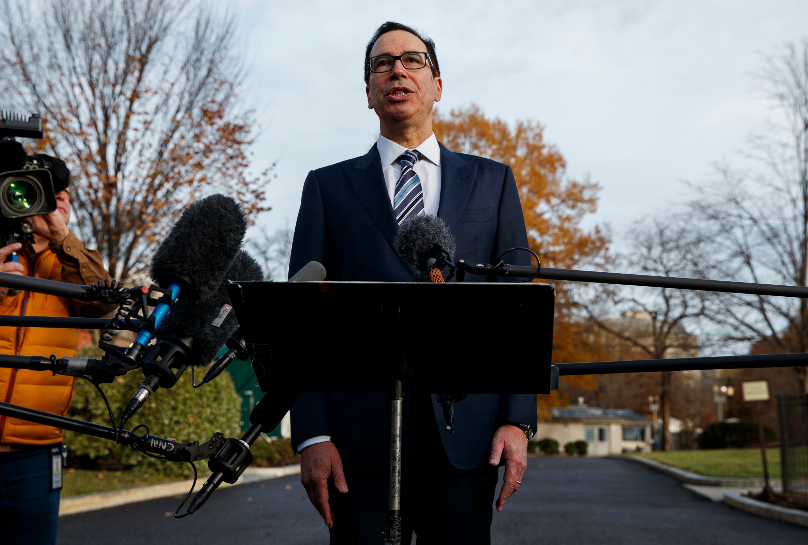 In this Dec. 3, 2018, file photo, Treasury Secretary Steve Mnuchin talks with reporters at the White House in Washington. Trump says he has confidence in Mnuchin, calling him a "very talented guy" and a "very smart person."