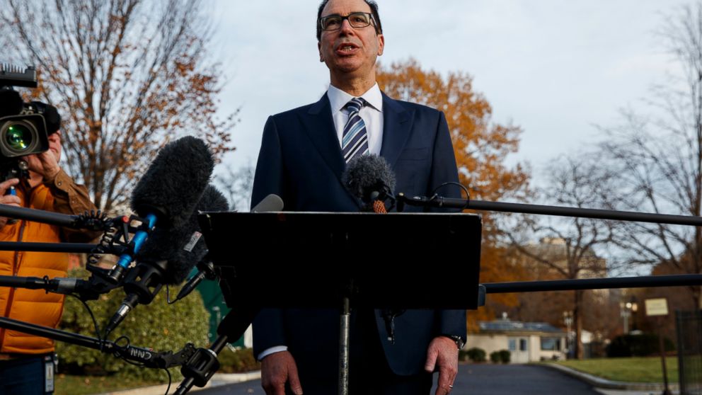 In this Dec. 3, 2018, file photo, Treasury Secretary Steve Mnuchin talks with reporters at the White House in Washington. Trump says he has confidence in Mnuchin, calling him a "very talented guy" and a "very smart person."