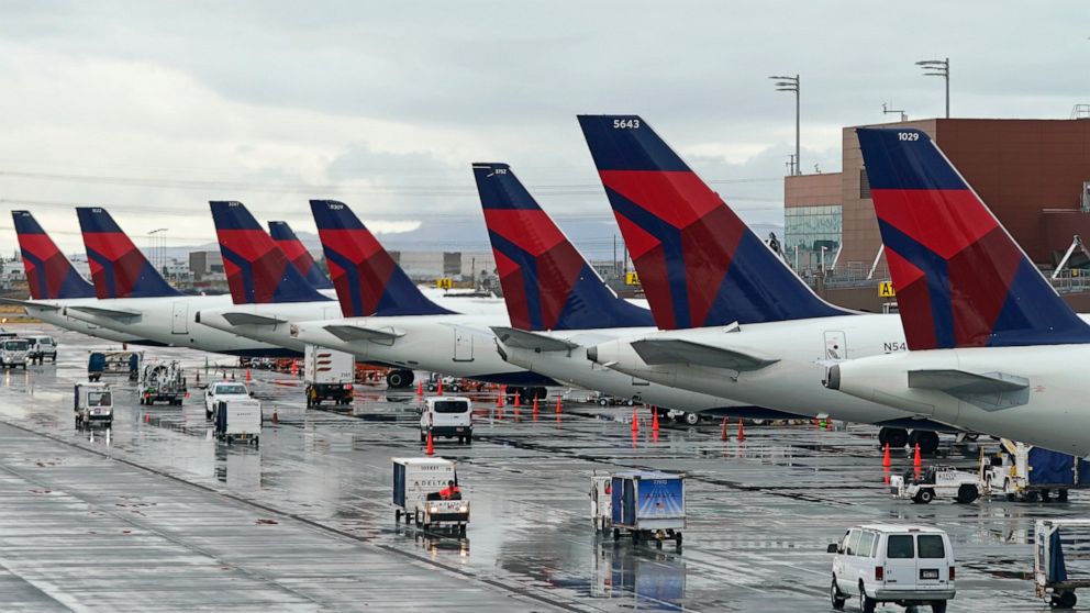FILE - Delta planes sit at their gates on June 13, 2022, at Salt Lake City International Airport, in Salt Lake City. Delta Air Lines has agreed to pay $10.5 million to settle charges it falsified information about deliveries of international mail, in