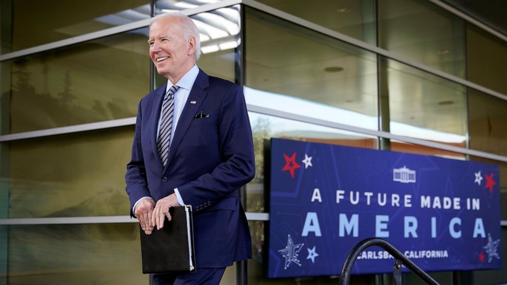 President Joe Biden smiles as he walks onto stage after being introduced by Taryne Haskamp to speak about the CHIPS and Science Act, a measure intended to boost the semiconductor industry and scientific research, at communications company ViaSat, Fri