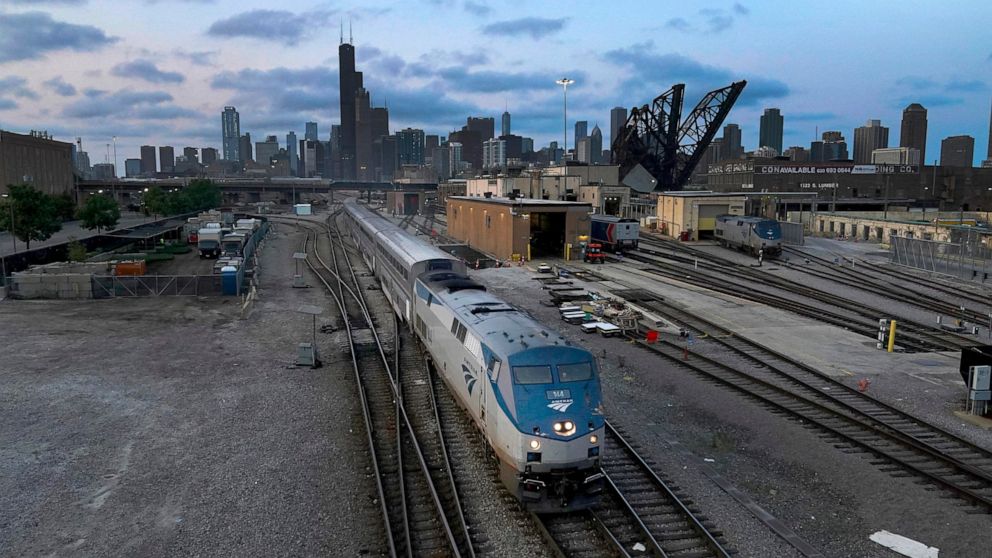 FILE - An Amtrak passenger train departs Chicago in the early evening headed south on Sept. 14, 2022, in Chicago. American consumers and nearly every industry will be affected if freight trains grind to a halt in December. Roughly half of all commute