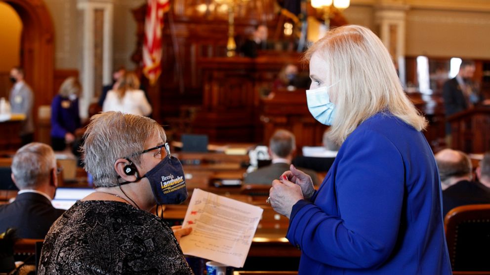 Kansas state Reps. Brenda Landwehr, left, R-Wichita, and Susan Concannon, R-Beloit, confer during a House debate on a proposed anti-abortion amendment to the Kansas Constitution, Friday, Jan. 22, 2021, at the Statehouse in Topeka, Kan. Both supported
