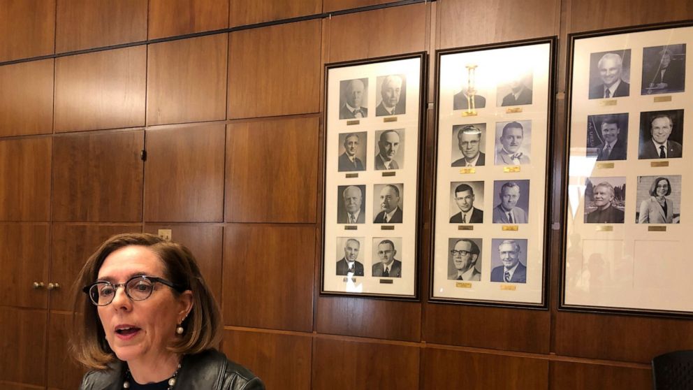 In this Feb. 7, 2019, file photo, Oregon Gov. Kate Brown speaks to reporters in front of pictures of previous state governors in Salem, Ore.