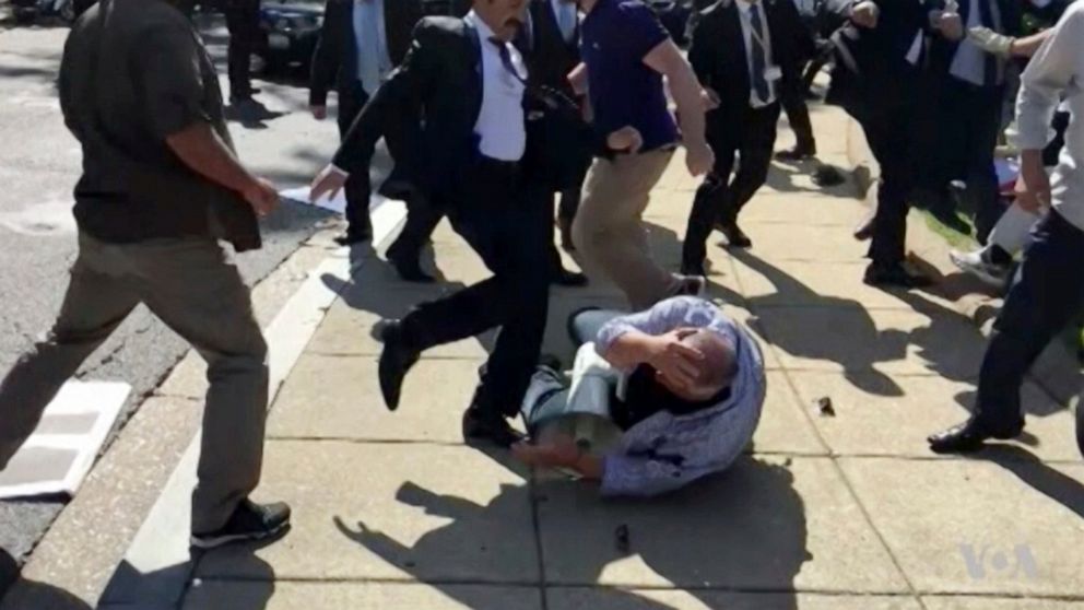 FILE- In this file frame grab from video provided by Voice of America, members of Turkish President Recep Tayyip Erdogan's security detail are shown violently reacting to peaceful protesters during Erdogan's trip last month to Washington. The Supreme
