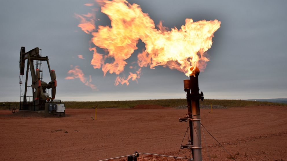FILE - A flare burns natural gas at an oil well Aug. 26, 2021, in Watford City, N.D. The Biden administration is delaying decisions on new federal oil and gas drilling and other energy-related actions after a federal court ruling blocked the way offi