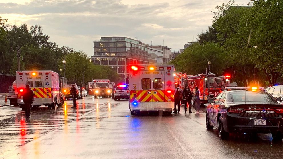 In this photo provided by @dcfireems, emergency medical crews are staged on Pennsylvania Avenue between the White House and Lafayette Park, Thursday evening, Aug. 4, 2022 in Washington. Two people who were critically injured in a lightning strike in 