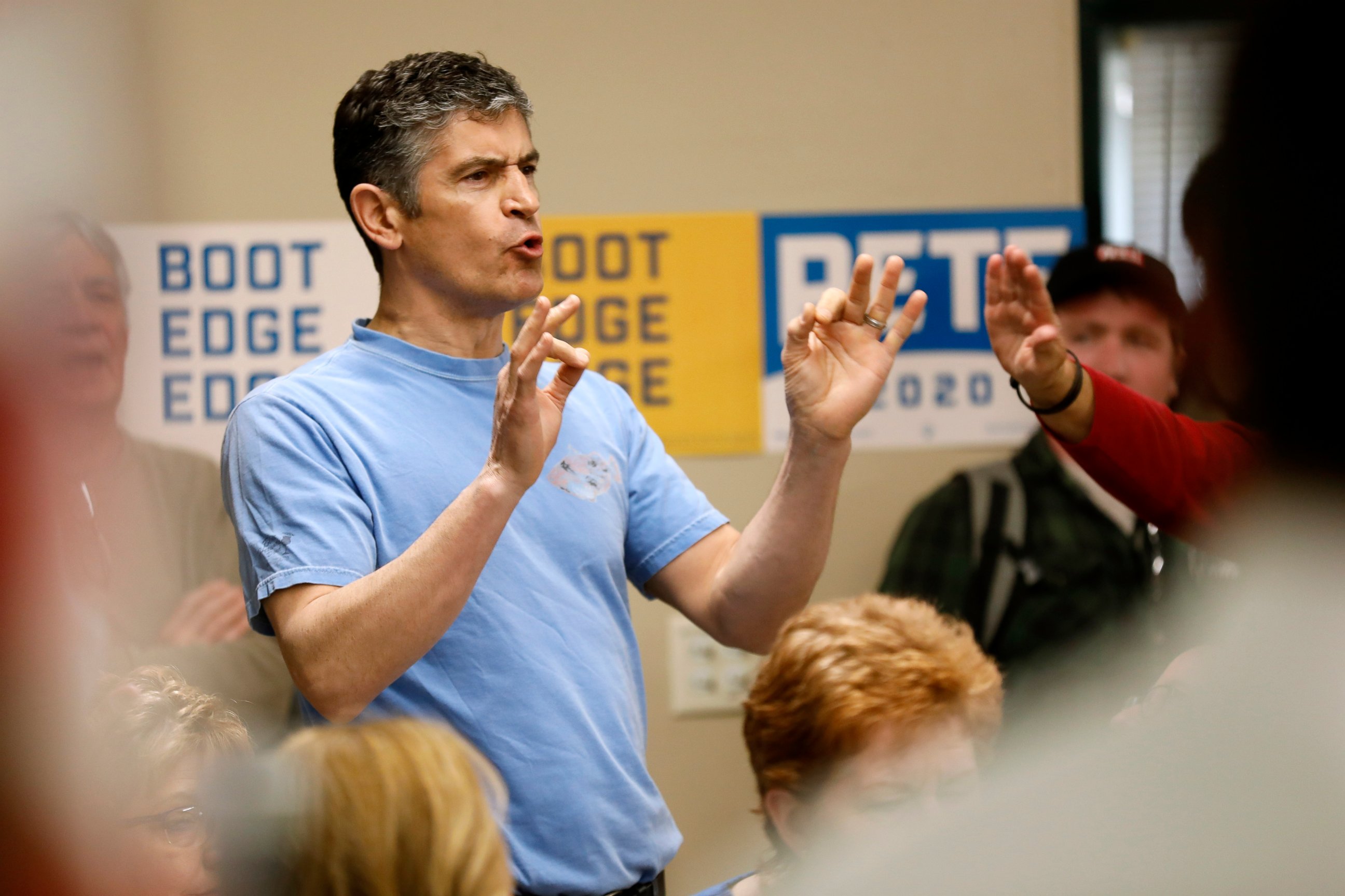 A protester shouts as 2020 Democratic presidential candidate, South Bend Mayor Pete Buttigieg speaks during a town hall meeting, Tuesday, April 16, 2019, in Fort Dodge, Iowa. 