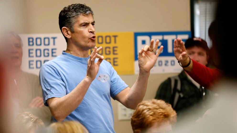 A protester shouts as 2020 Democratic presidential candidate, South Bend Mayor Pete Buttigieg speaks during a town hall meeting, Tuesday, April 16, 2019, in Fort Dodge, Iowa. 