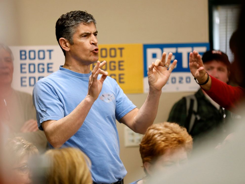 A protester shouts as 2020 Democratic presidential candidate, South Bend Mayor Pete Buttigieg speaks during a town hall meeting, Tuesday, April 16, 2019, in Fort Dodge, Iowa.