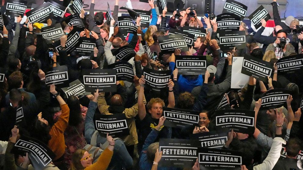 Supporters of Pennsylvania Lt. Gov. John Fetterman, Democratic candidate for U.S. Senate, waves signs during an election night party in Pittsburgh, Wednesday, Nov. 9, 2022. (AP Photo/Gene J. Puskar)