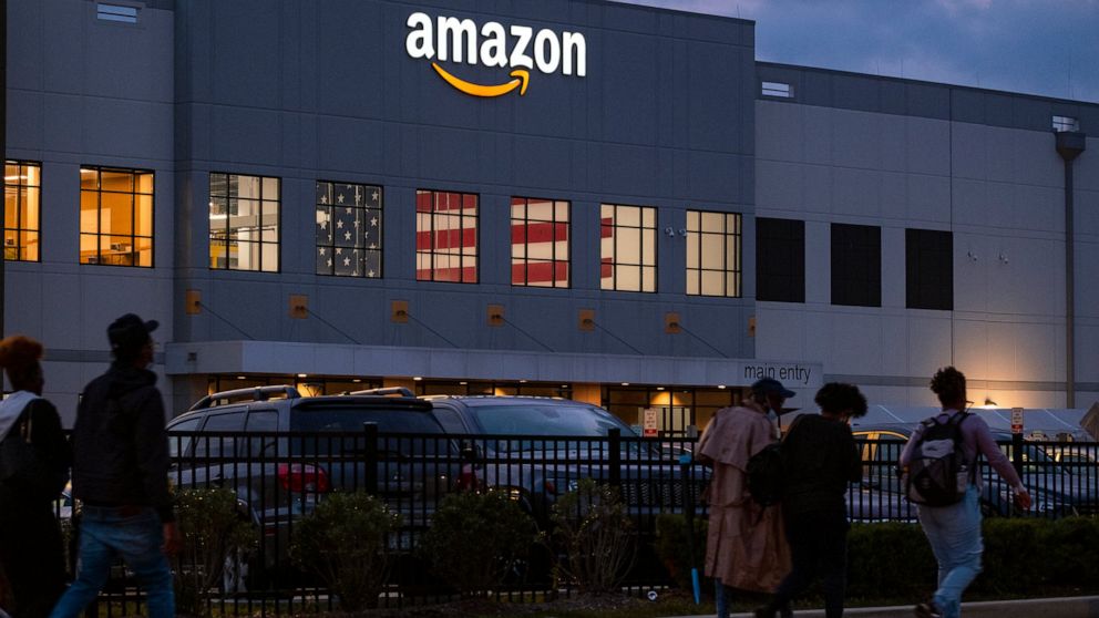 FILE - People arrive for work at the Amazon distribution center in the Staten Island borough of New York, on Oct. 25, 2021. A federal labor board has denied Amazon's request to bar the public from a hearing on the company's bid to overturn a historic