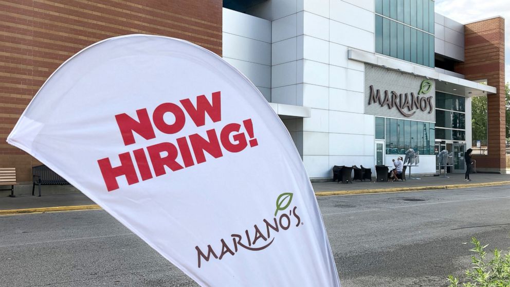 A sign in the parking lot of Mariano's grocery store advertises the availability of jobs Friday, Oct. 8, 2021, in Chicago. One reason America’s employers are having trouble filling jobs was starkly illustrated in a report Tuesday, Oct. 12: Americans 