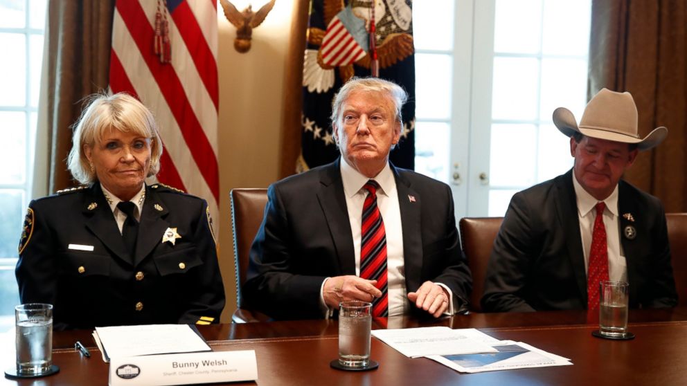 President Donald Trump, with Carolyn "Bunny" Welsh, sheriff of Chester County, Pa., left, and AJ Louderback, sheriff of Jackson County, Texas, attends a roundtable discussion on border security with local leaders, Friday Jan. 11, 2019.