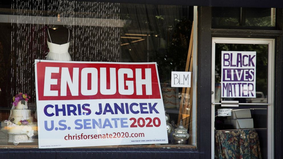 An election sign for Democratic Senate candidate Chris Janicek is seen in Omaha, Neb., Tuesday, June 16, 2020. The Nebraska Democratic Party is calling on its U.S. Senate nominee to drop out of the race after he made sexually repugnant comments about