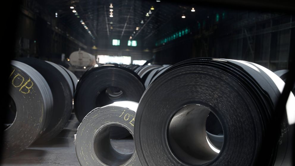 FILE- This June, 28, 2018, photo shows rolls of finished steel at a facility in Granite City, Ill. The president frequently boasts that the taxes he’s imposed on imports, steel and aluminum and nearly half of all goods from China, have showered the U