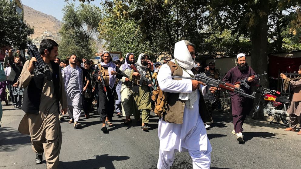 Taliban soldiers walk towards Afghans shouting slogans, during an anti-Pakistan demonstration, near the Pakistan embassy in Kabul, Afghanistan, Tuesday, Sept. 7, 2021. (AP Photo/Wali Sabawoon)