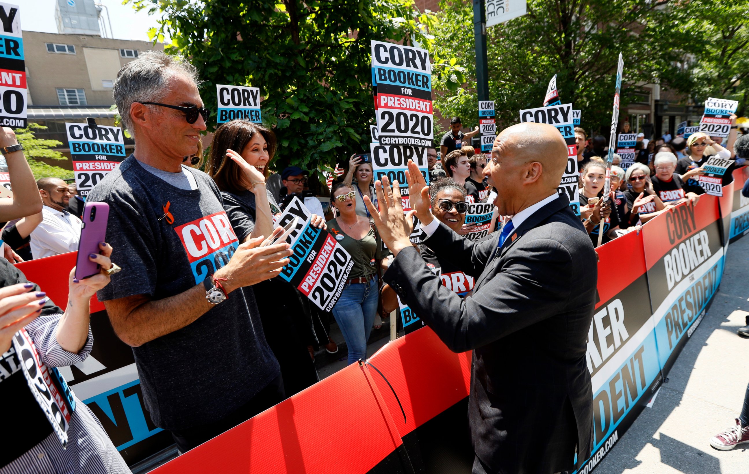 Democratic presidential candidate Cory Booker, right, greets supporters before the Iowa Democratic Party's Hall of Fame Celebration, Sunday, June 9, 2019, in Cedar Rapids, Iowa.