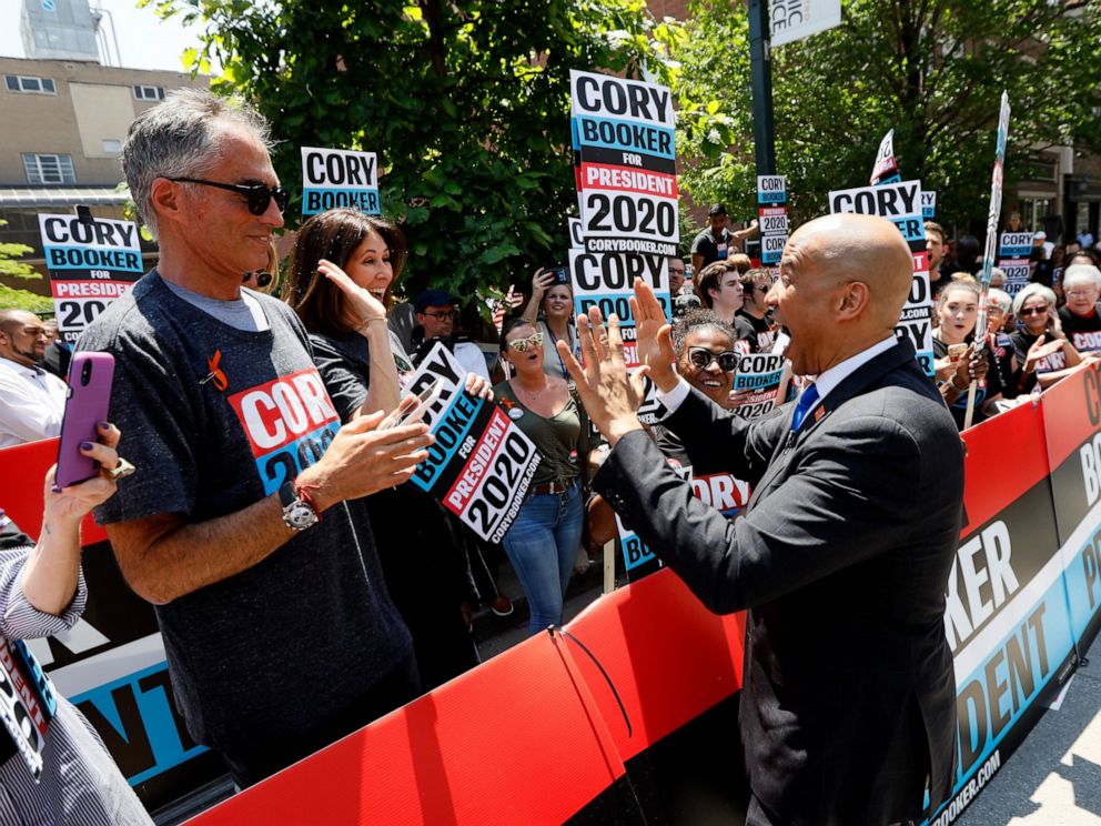 Democratic presidential candidate Cory Booker, right, greets supporters before the Iowa Democratic Partys Hall of Fame Celebration, Sunday, June 9, 2019, in Cedar Rapids, Iowa.