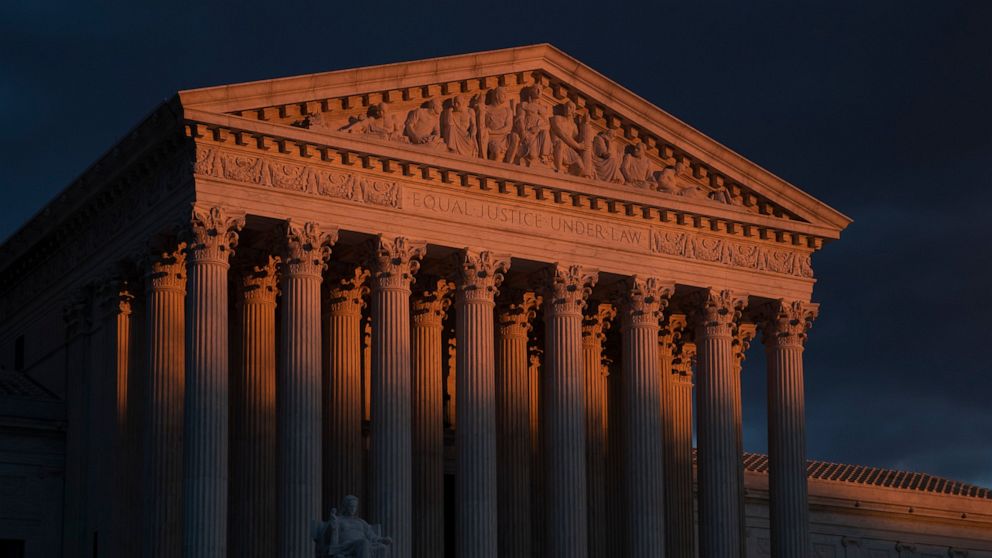 The Supreme Court is seen at sunset in Washington, on Jan. 24, 2019. The Supreme Court will hear arguments on Oct. 11, 2022, over a California animal cruelty law that could raise the cost of bacon and other pork products nationwide. (AP Photo/J. Scot
