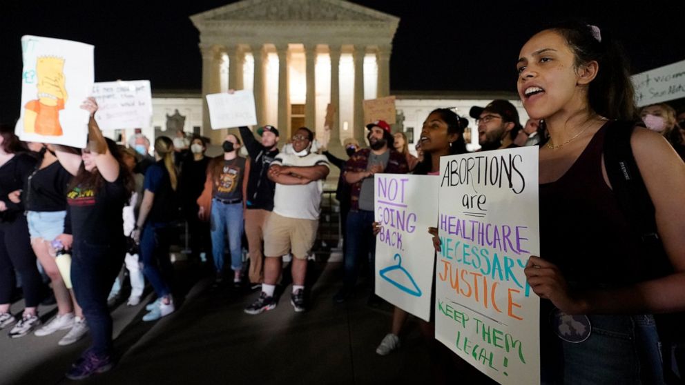 A crowd of people gather outside the Supreme Court, early Tuesday, May 3, 2022 in Washington. A draft opinion circulated among Supreme Court justices suggests that earlier this year a majority of them had thrown support behind overturning the 1973 ca