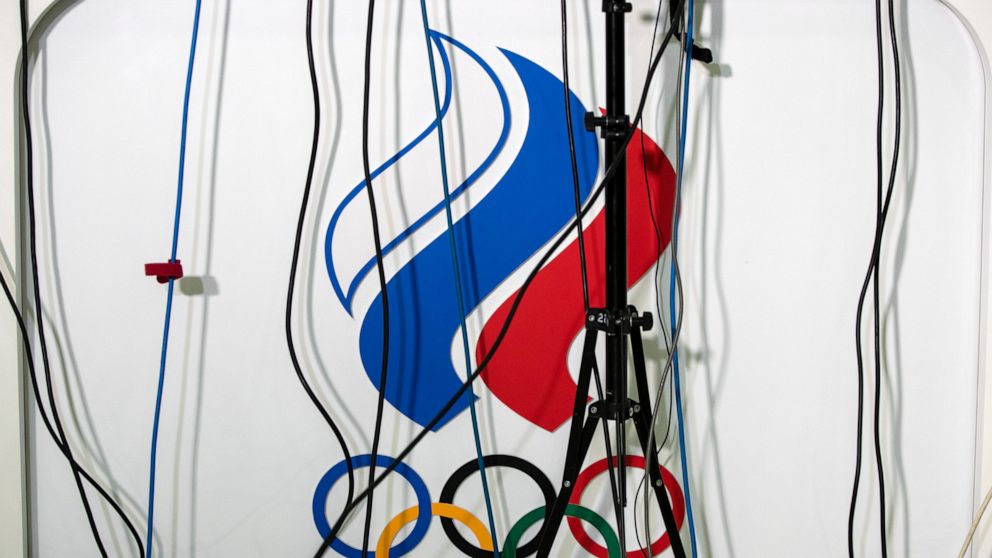 Wires go to microphones above a logo of the Russian Olympic Committee during President of the Russian Olympic Committee Stanislav Pozdnyakov's news conference in Moscow, Russia, Monday, Dec. 9, 2019. The World Anti-Doping Agency has banned Russia fro