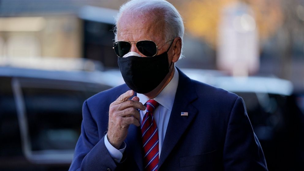 FILE - In this Nov. 23, 2020, file photo President-elect Joe Biden walks from his motorcade to speak to members of the media in Wilmington, Del. The big tech companies enjoyed a cozy relationship with the Obama-Biden administration. Joe Biden is back