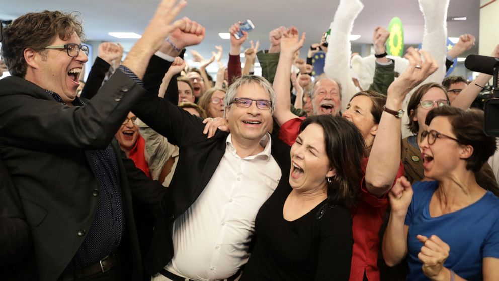 Green party chairwoman Annalena Baerbock and EU parliament member Sven Giegold celebrate after the first results in Berlin, Germany, Sunday, May 26, 2019. (Kay Nietfeld/dpa via AP)
