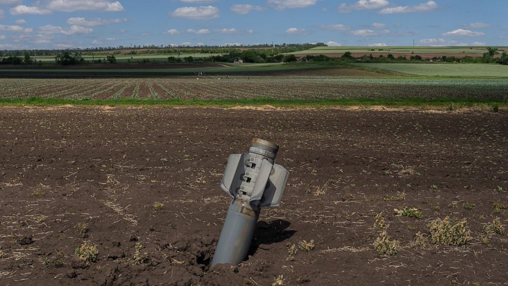 An unexploded Russian rocket lays on a field near Soledar, eastern Ukraine, Monday, June 6, 2022. (AP Photo/Bernat Armangue)