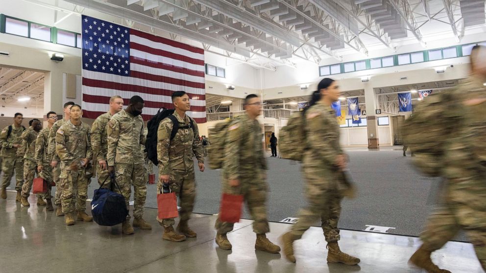 FILE - About 130 soldiers with the U.S. Army's 87th Division Sustainment Support Battalion, 3rd Division Sustainment Brigade, wait to board a chartered plane during their deployment to Europe, March 11, 2022, at Hunter Army Airfield in Savannah, Ga. 