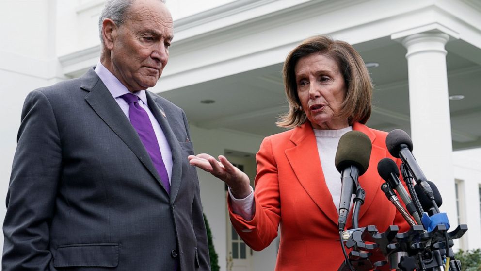 FILE - Senate Majority Leader Chuck Schumer of N.Y., right, listens as House Speaker Nancy Pelosi of Calif., left, speaks to reporters at the White House in Washington, Nov. 29, 2022, about their meeting with President Joe Biden. Congress is moving s