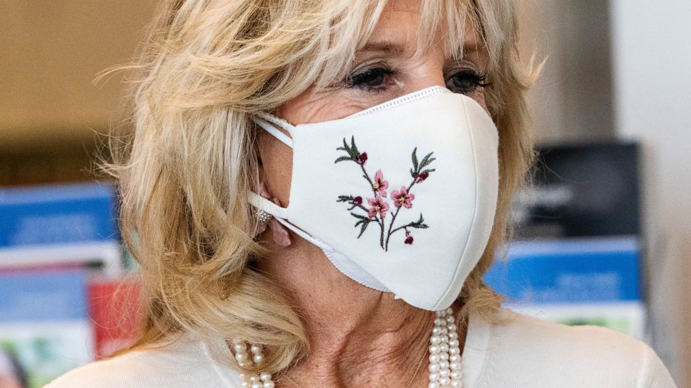 First lady Jill Biden's necklace says "Mama," as she takes a tour of Whitman-Walker Health, Friday, Jan. 22, 2021, in Washington. (AP Photo/Jacquelyn Martin, Pool)