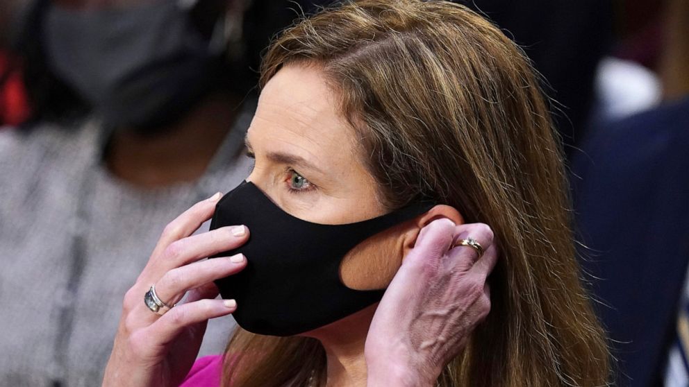 Supreme Court nominee Amy Coney Barrett puts her face mask back on after taking a drink during her Senate Judiciary Committee confirmation hearing on Capitol Hill in Washington, Monday, Oct. 12, 2020. (Kevin Dietsch/Pool via AP)