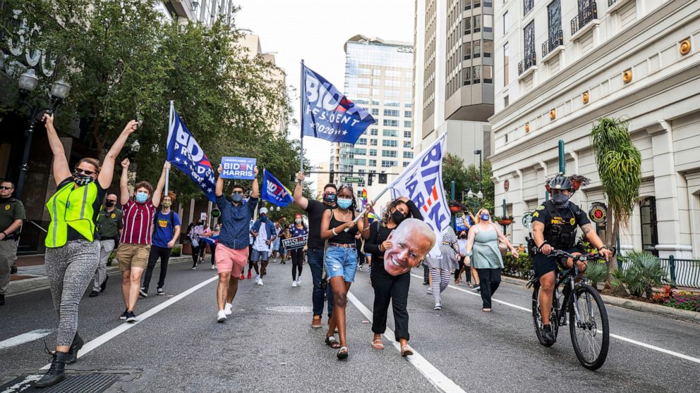 FILE - In this Nov. 7, 2020 file photo, President-elect Joe Biden supporters march down Orange Avenue on their way to Orlando City Hall in Orlando, Fla. Democrats hope to make deeper strides in changing their fortunes in a state that has become frien