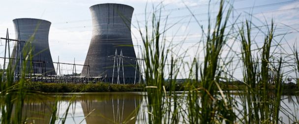 FILE - In this Wednesday, Sept. 7, 2016 file photo, two cooling towers can be seen in the reflection of a pond outside of the unfinished Bellefonte Nuclear Plant, in Hollywood, Ala. Real estate mogul Franklin Haney contributed $1 million to President