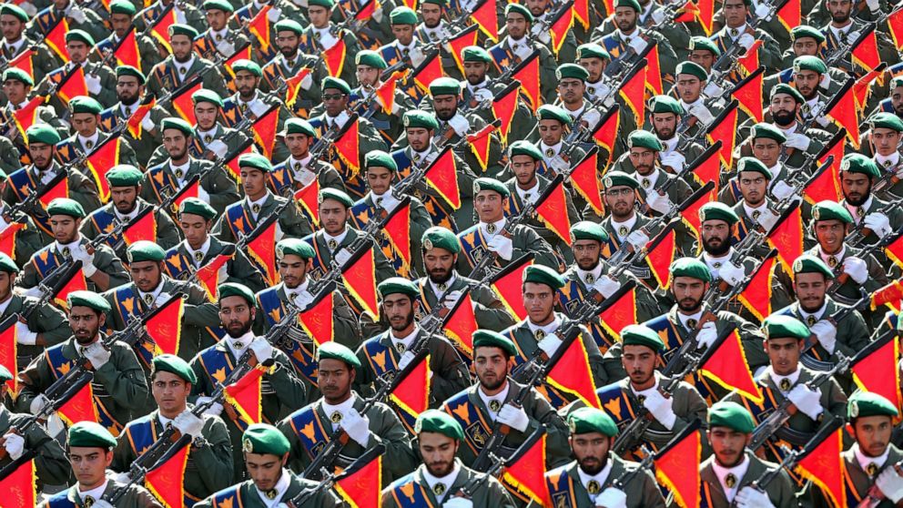 FILE - In this Sept. 21, 2016 file photo, Iran's Revolutionary Guard troops march in a military parade marking the 36th anniversary of Iraq's 1980 invasion of Iran, in front of the shrine of late revolutionary founder Ayatollah Khomeini, just outside