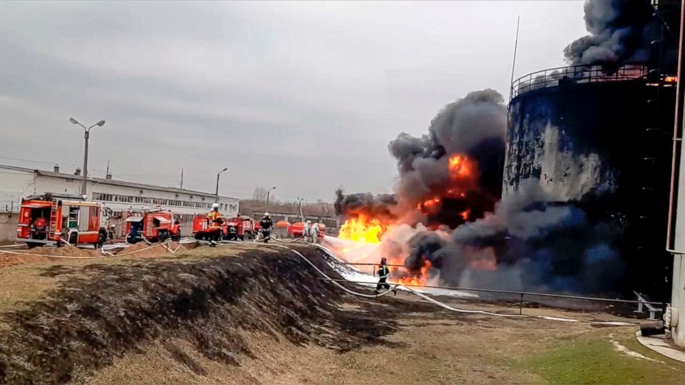 In this handout photo released by Russian Emergency Ministry Press Service on Friday, April 1, 2022, firefighters work at the site of fire at an oil depot in Belgorod region, Russia. The governor of the Russian border region of Belgorod accused Ukrai