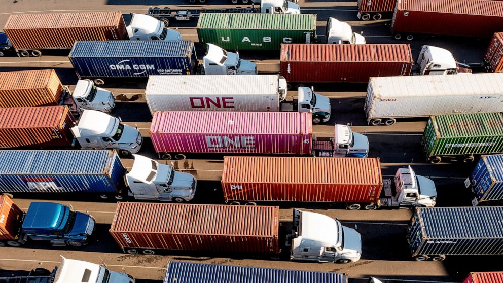 FILE - Trucks line up to enter a Port of Oakland shipping terminal on Nov. 10, 2021, in Oakland, Calif. The pandemic has receded as a top priority in many voters’ minds to start 2022, with the economy overshadowing coronavirus concerns and worries ab