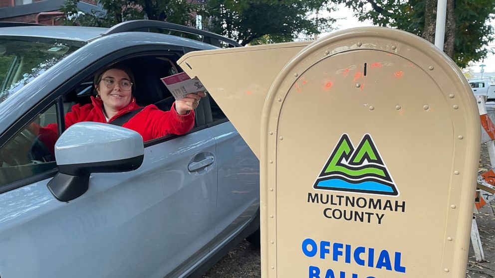 FILE - A voter drops off a ballot in a drop box in Portland, Ore., on Election Day, Tuesday, Nov. 8, 2022. Oregon is losing its second elections director in as many years, with the current one announcing her resignation, saying the job is extremely c