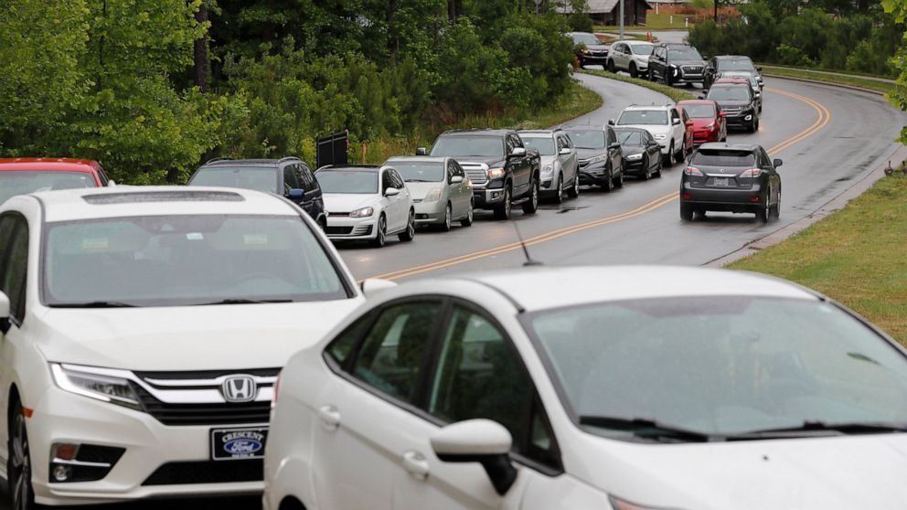 Cars line up on Pine Plaza Drive for gas at the Costco in Apex, N.C., Wednesday, May 12, 2021. Several gas stations in the Southeast reported running out of fuel, primarily because of what analysts say is unwarranted panic-buying among drivers, as th