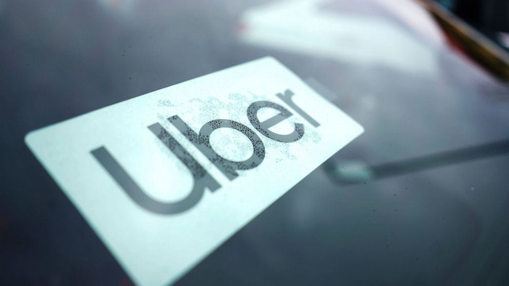 An Uber sign is displayed inside a car in Palatine, Ill., Thursday, Feb. 10, 2022. As Uber pushed into markets around the world, the ride-sharing service lobbied political leaders to relax labor and taxi laws and used a “kill switch″ to thwart regula