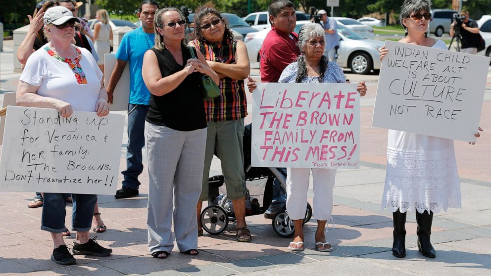 FILE - Participants listen during a rally in support of three-year-old baby Veronica, Veronica's biological father, Dusten Brown, and the Indian Child Welfare Act, in Oklahoma City, Monday, Aug. 19, 2013. Brown is trying to maintain custody of the gi