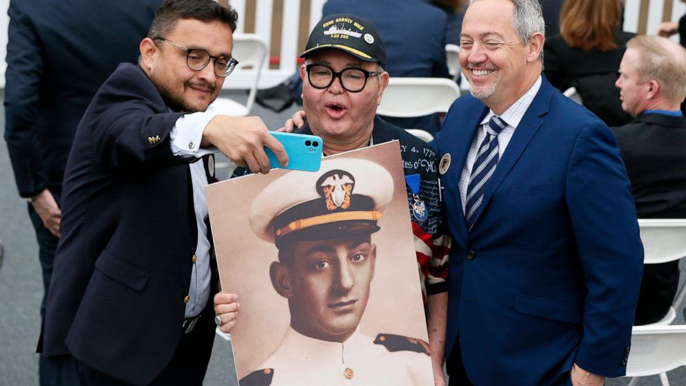 David Campos, left, vice chair of the California Democratic Party, takes a selfie with Nicole Murray-Ramirez, center, an LGBT activist, holding a photo of Harvey Milk, and Bevan Dufty, right, director of the San Francisco Bay area rapid transit distr