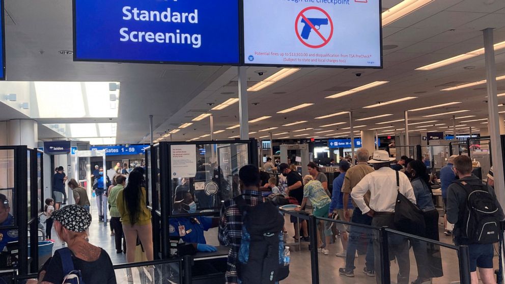 FILE - A sign warns travelers not to bring guns through the Transportation Security Administration checkpoint at Orlando International Airport in Orlando, Fla, on April 23, 2022. The TSA said Friday, Dec. 16, 2022, it is raising the fine for people c