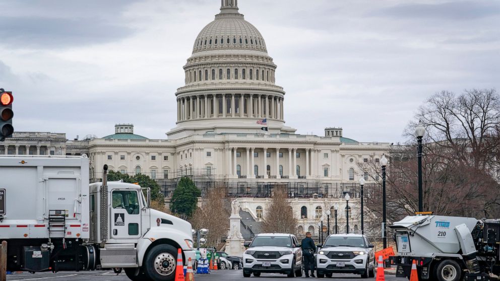 Heavy vehicles, including garbage trucks and snow plows, are set near the entrance to Capitol Hill at Pennsylvania Avenue and 3rd Street NW in Washington, Tuesday, Feb. 22, 2022, amid reports that trucker protests will arrive on March 1, the day of P