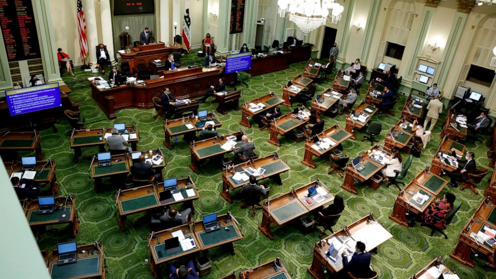 FILE - In this May 26, 2020, file photo, members of the state Assembly meet at the Capitol in Sacramento, Calif. On Thursday, July 15, 2021, California lawmakers are scheduled to vote on a bill that would fund guaranteed income programs across the st